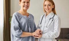 smiley-covid-recovery-center-female-doctor-holding-elder-patient-s-hands_23-2148847831