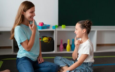 psychologist-helping-little-girl-speech-therapy_23-2149113813