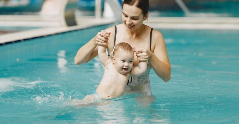 little-cute-baby-boy-mother-with-son-family-playing-water_1157-42263