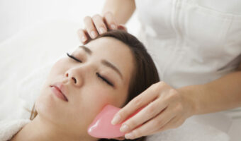 Woman receiving face massage for health