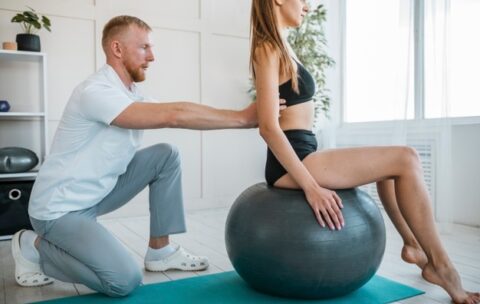 woman-doing-exercises-with-ball-and-physiotherapist_23-2148789851